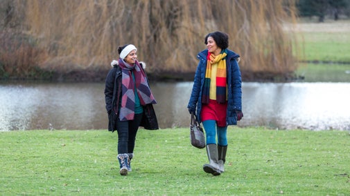 Walking through the parkland in winter at Kedleston Hall, Derbyshire